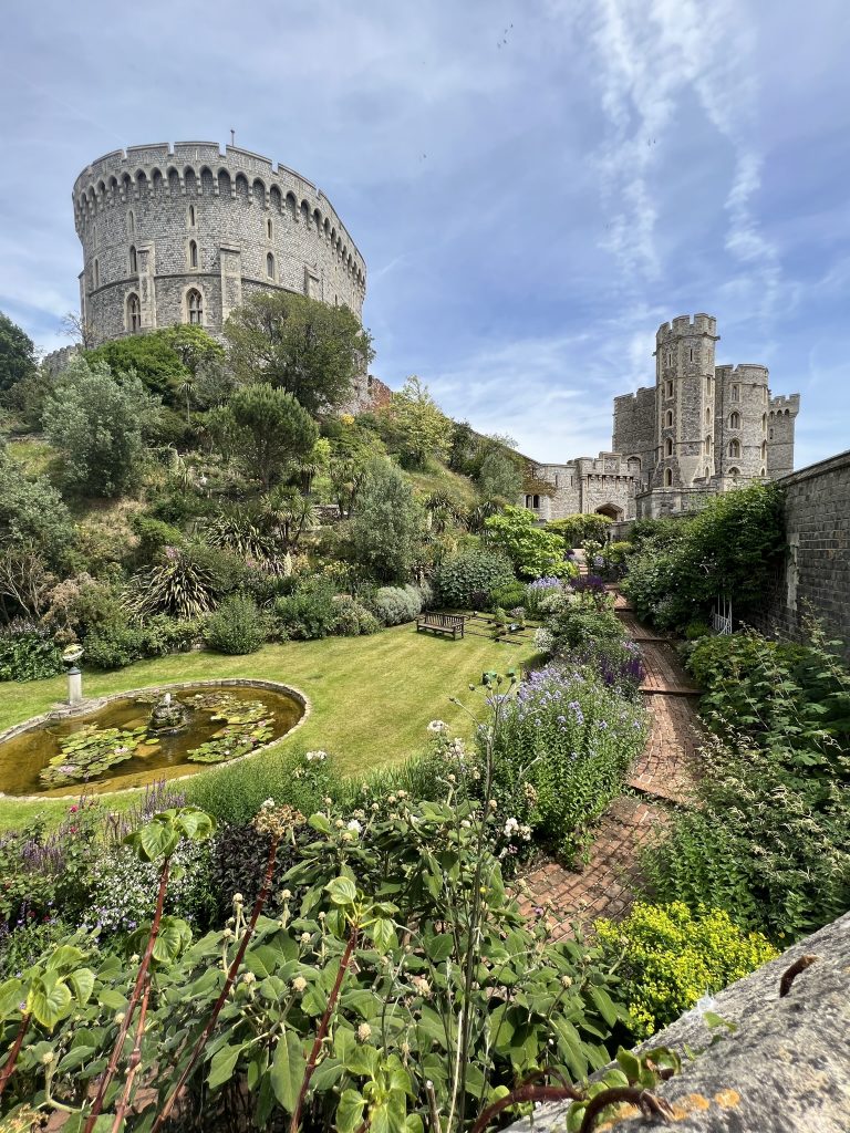Windsor Castle with the iconic round tower in the background with the sloping garden in the foreground.
