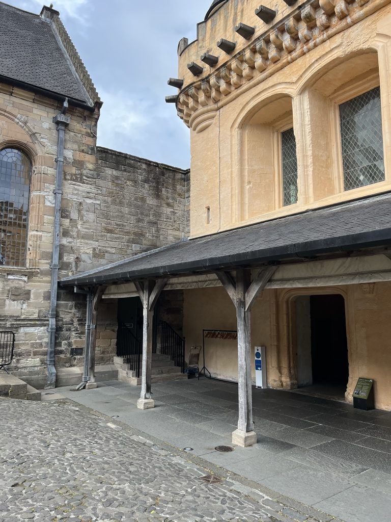 From the castle courtyard you can see the entrance to the Great Hall.  The outside of the building is painted the "kings gold" which is a yellowish gold. Next to the Great Hall is the Chapel Royale that is in its natural stone. 