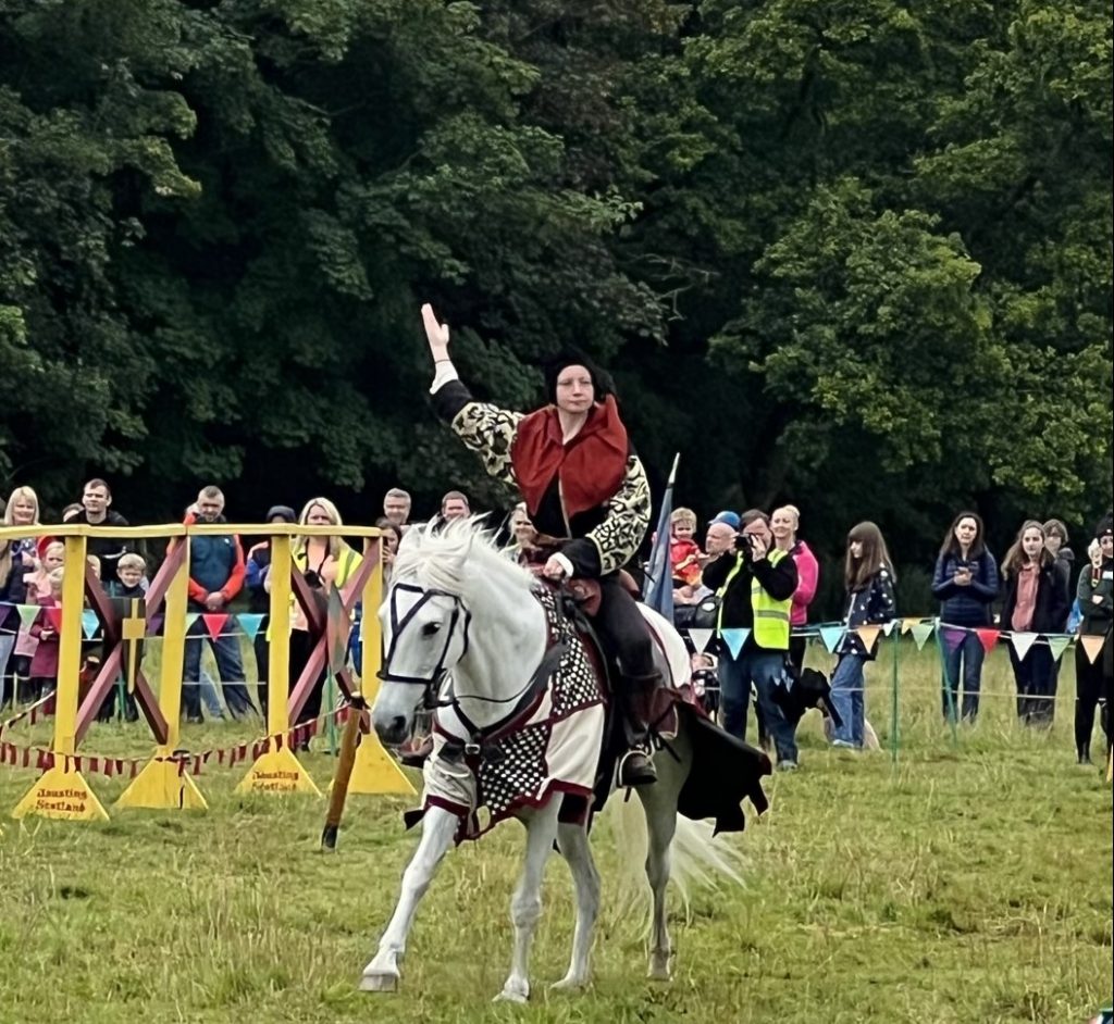 The squire riding the white horse.