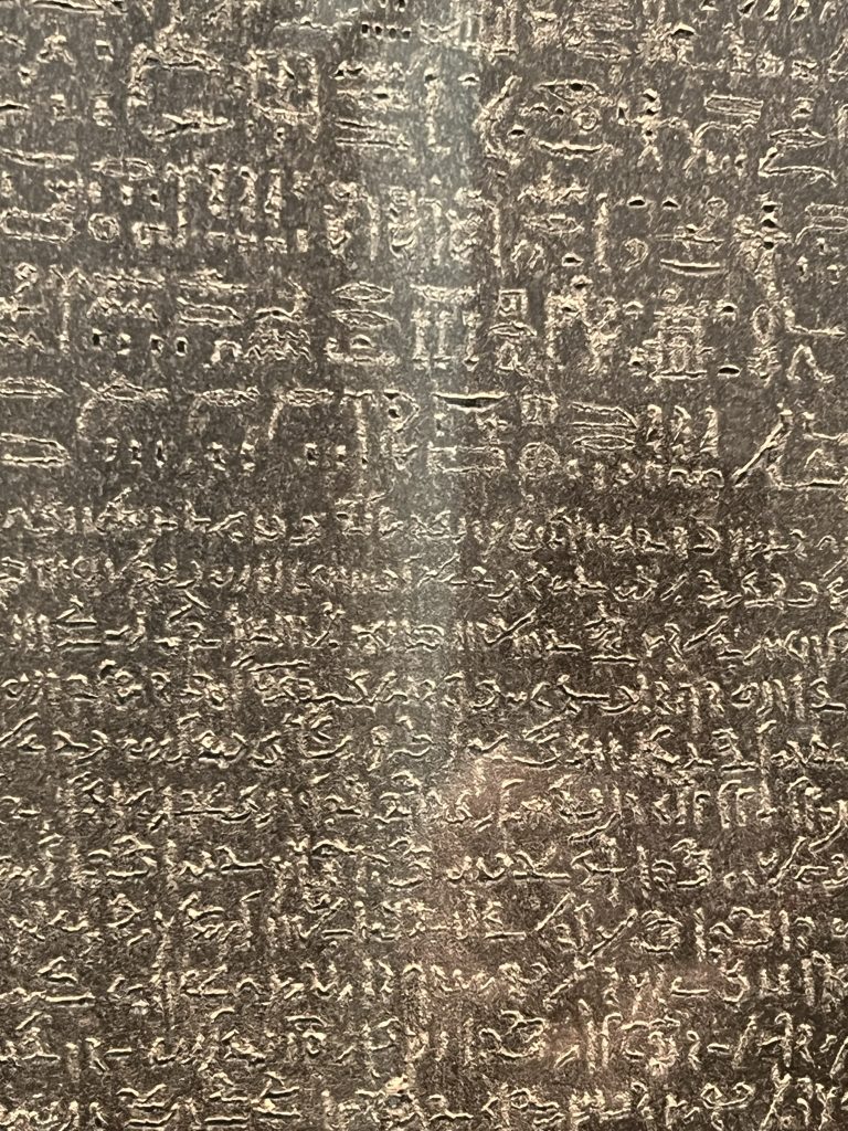 A close up of of the Rosetta Stone showing the hieroglyphic and Greek inscriptions.