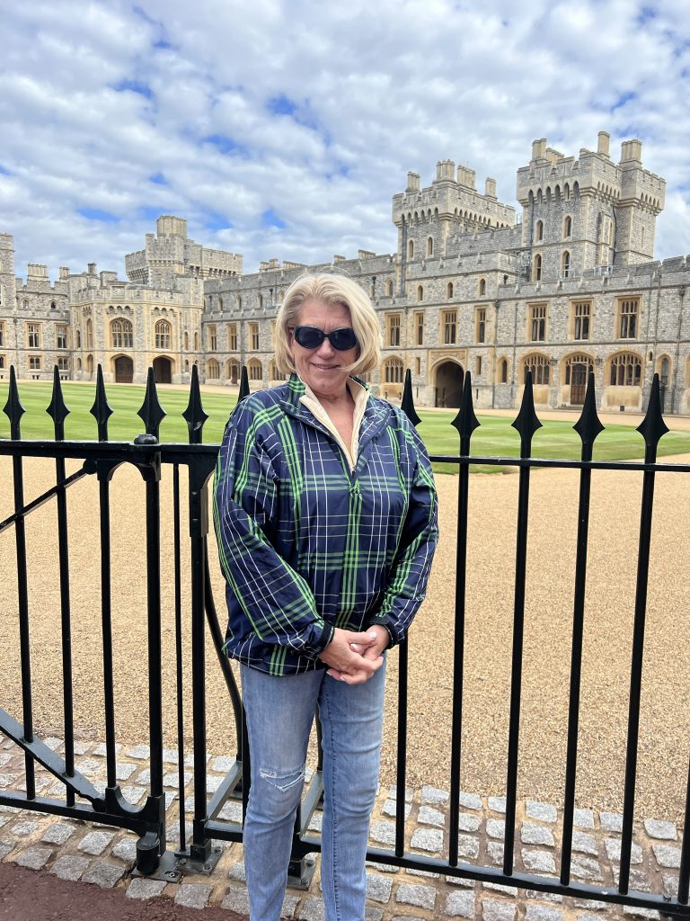Jodi standing in front of the fence outside of the Queen's Apartments.