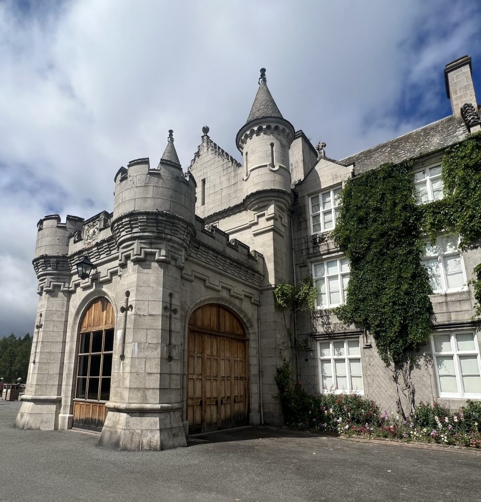 The front and side of the garage-like area.  There are decorative cross like engravings on the front of the garage and detailed carvings of the top of the garage-like area leading up to the turrets. 